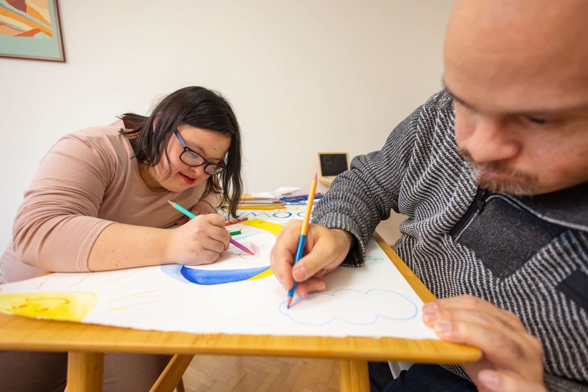 Young Women and a Man with Down Syndrome Collaborate